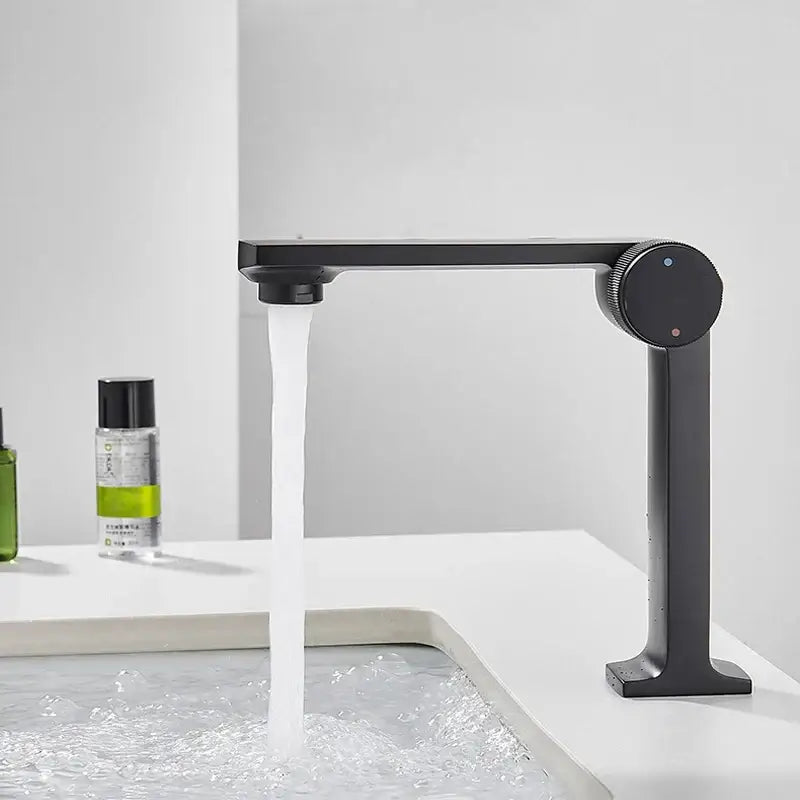 Modern matte black gold basin faucet with sleek minimalist design and integrated control knob by decorbites black gold