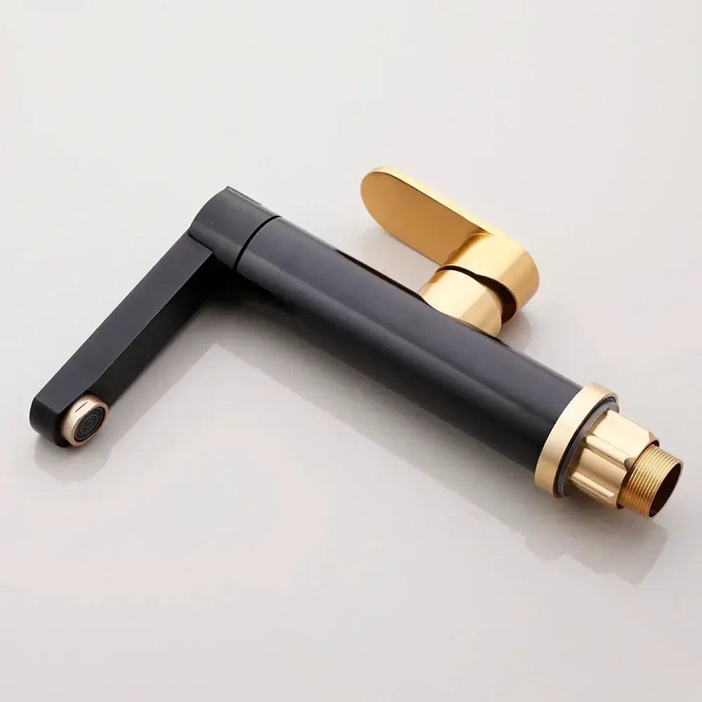 Black gold bathroom faucet with sleek angular spout and polished brass accents by decorbites black gold
