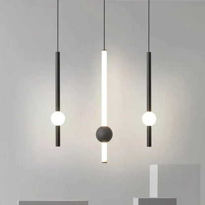 Modern minimalist decorbites black gold ceiling pendant with black cylindrical bodies and glowing white bulbs for bedroom use