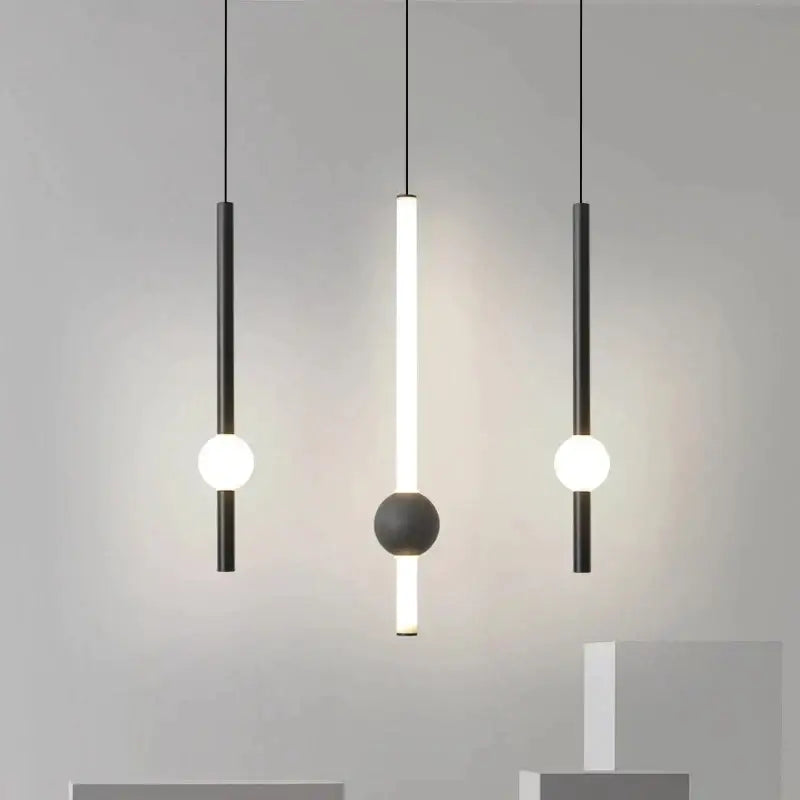 Modern minimalist decorbites black gold ceiling pendant with black cylindrical bodies and glowing white bulbs for bedroom use