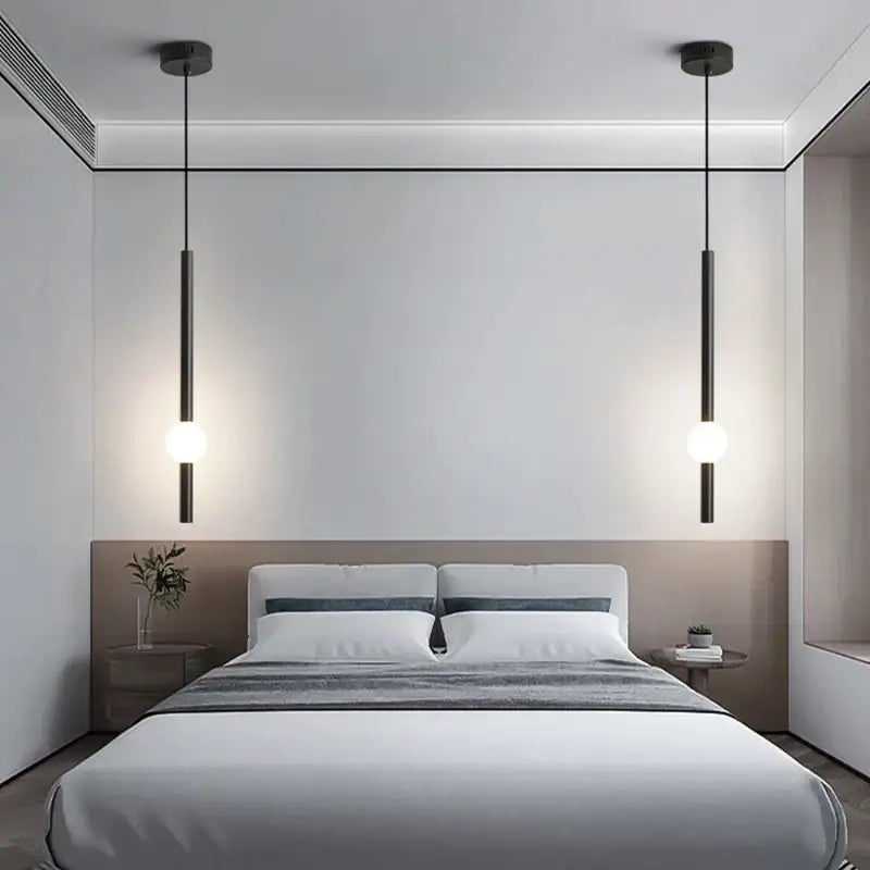 Minimalist decorbites black gold ceiling pendant with sleek black gold shades and warm LED orbs above bedroom bed