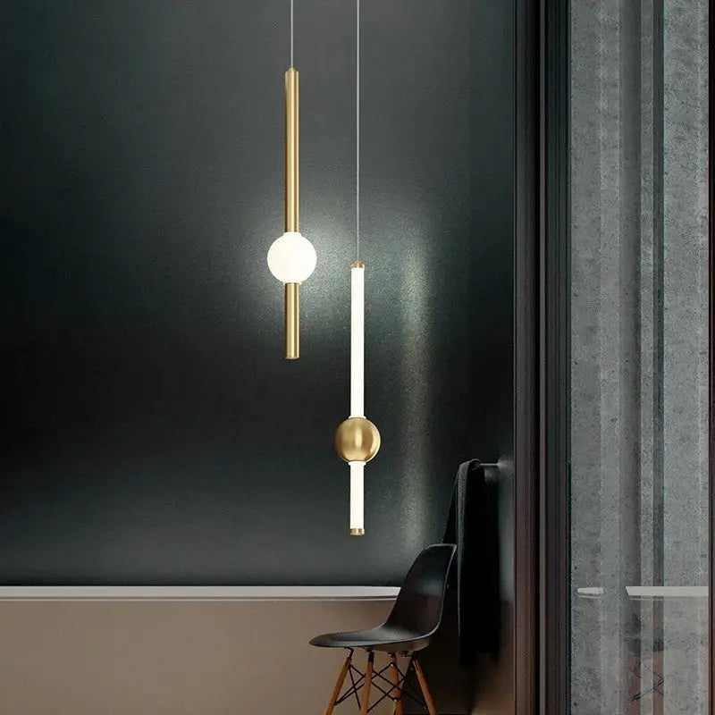 Two minimalist decorbites black gold ceiling pendants with white and gold rods and spherical bulbs for bedroom lighting