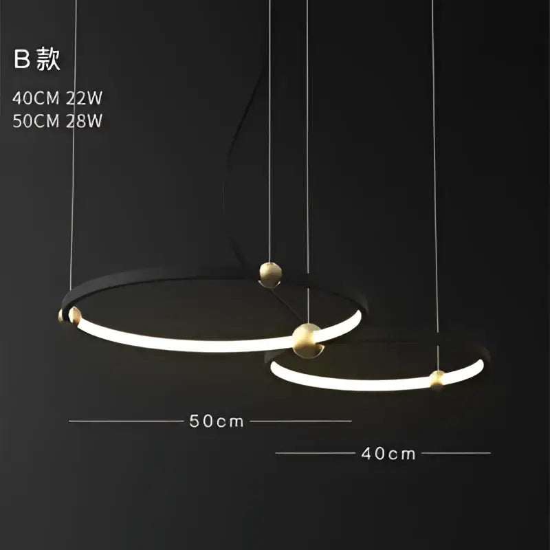 Modern minimalist decorbites black gold chandelier with two concentric black metal LED rings and polished gold accents