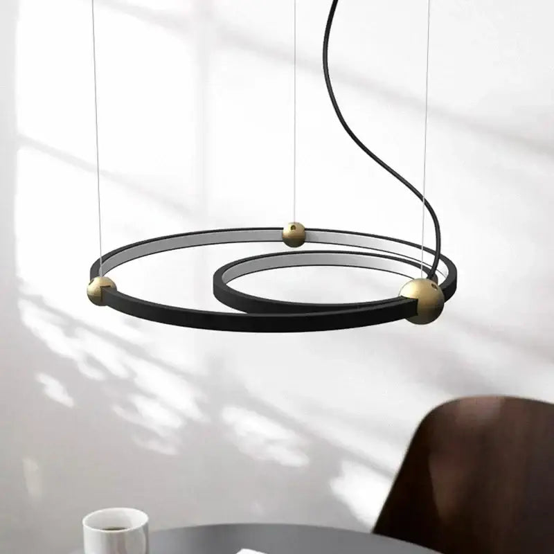 Modern black gold chandelier featuring sleek metal led rings in a minimalist decorbites black gold design