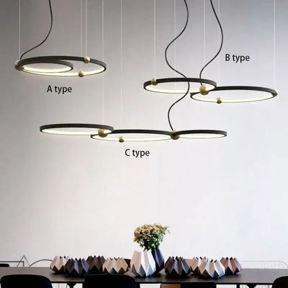 Modern minimalist decorbites black gold chandelier with sleek black metal rings and warm led gold-toned spherical accents