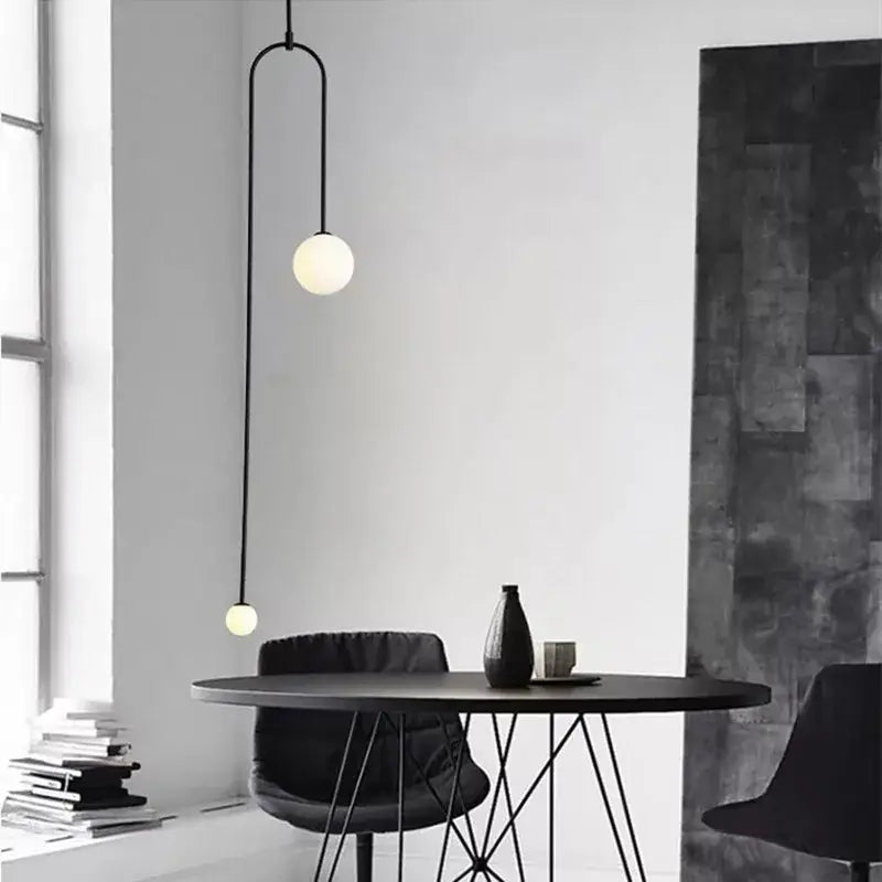 DecorBites black gold chandelier pendant with black minimalist metal arm and two spherical glass bulbs for modern decor
