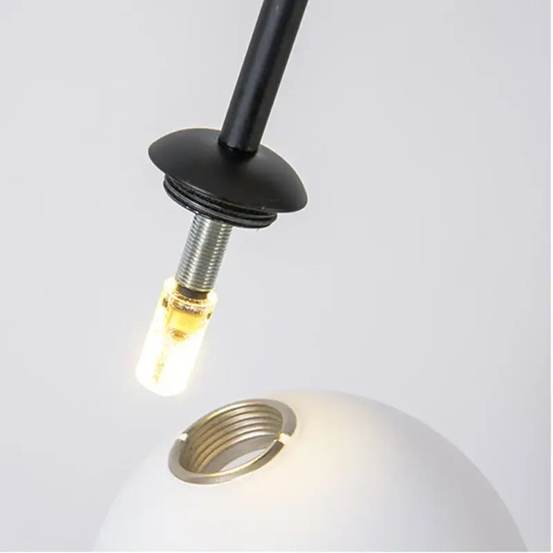 Decorbites black gold chandelier pendant featuring a sleek black metal frame with a frosted white glass globe and led bulb