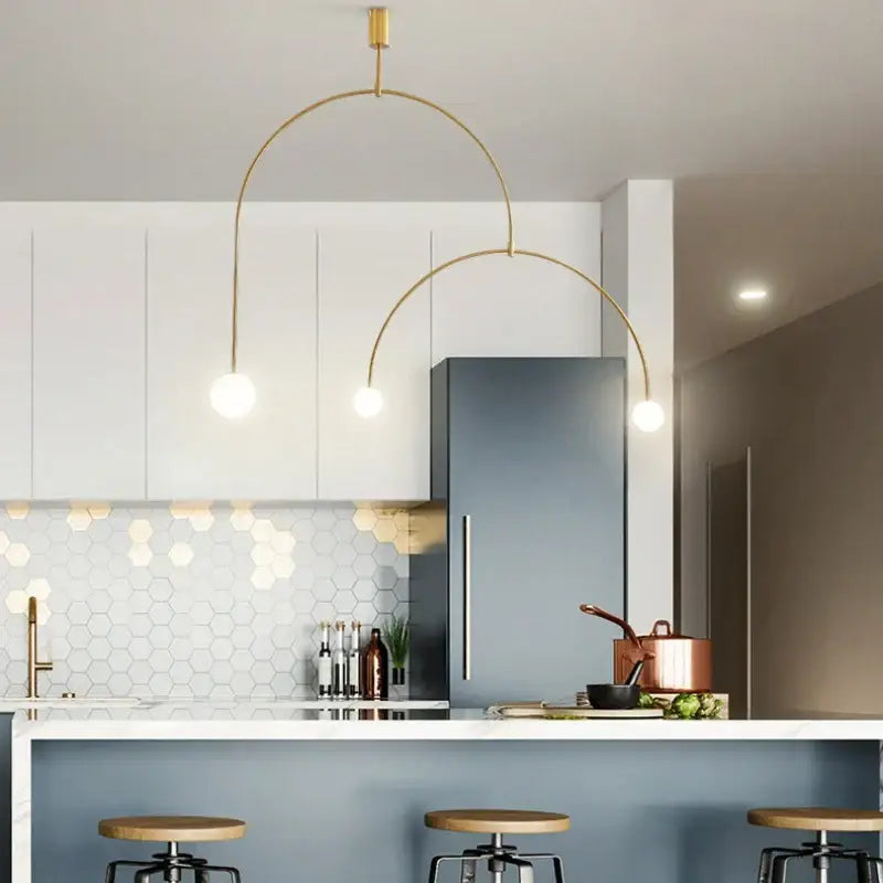 Decorbites black gold chandelier pendant with gold-toned arched design and spherical bulbs above modern kitchen island