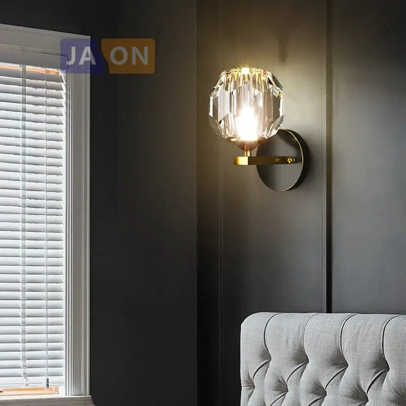DecorBites™ black gold copper crystal LED wall sconce light with faceted globe and gold-toned metal base for bedroom