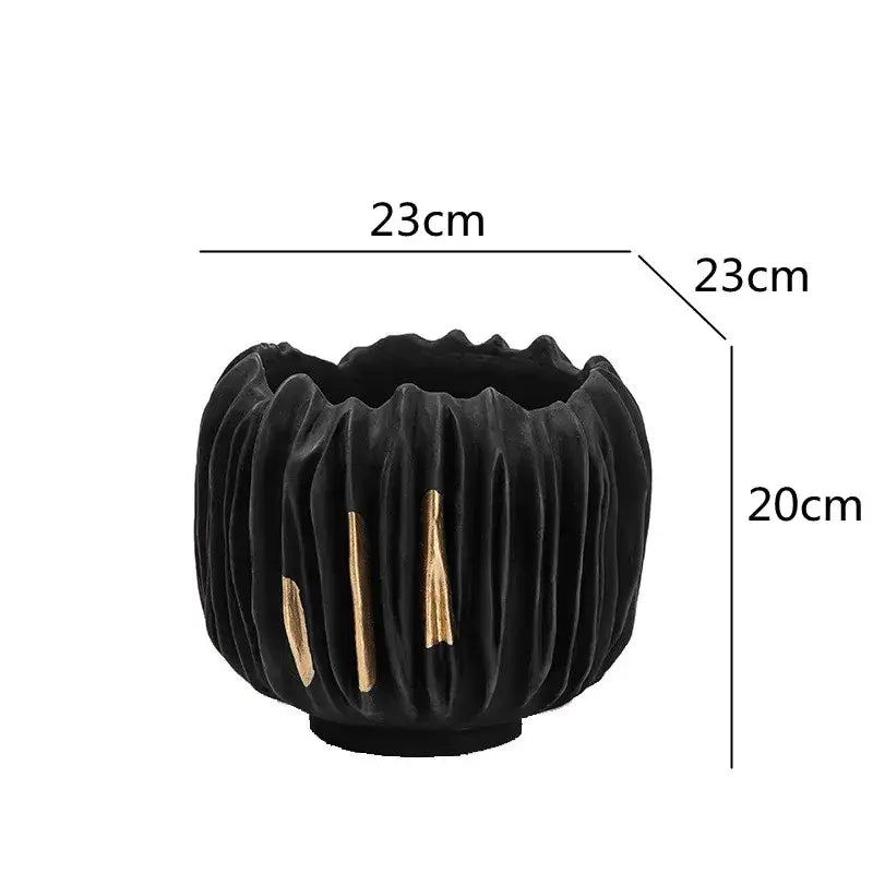 Black ceramic planter with vertical ridges and gold crease texture accent strips from decorbites black gold crease collection