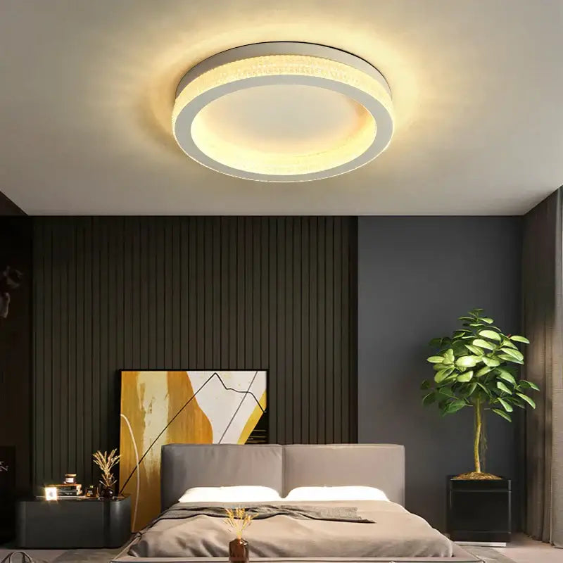 Modern circular decorbites black gold crystal chandelier ceiling light with sleek white frame and warm yellow glow for living room
