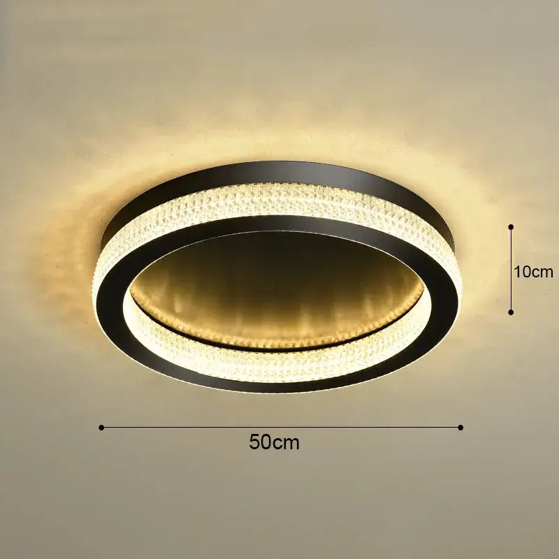 Modern black circular ceiling light with two crystal rings emitting warm gold light decorbites black gold chandelier