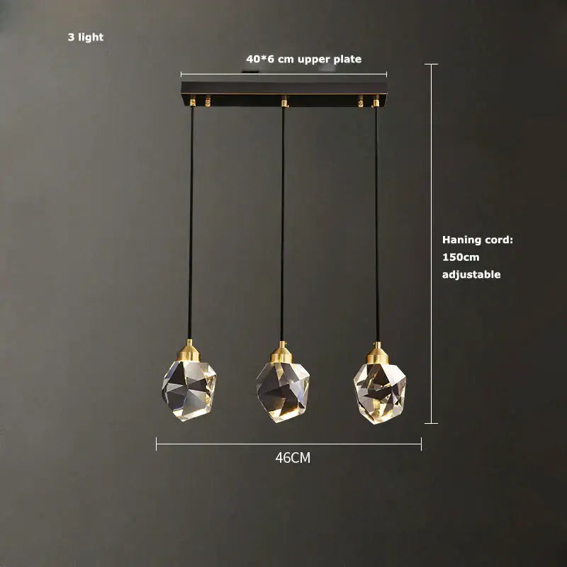 Modern three-light pendant lamp with black gold crystal globes and gold crystal chandelier accents by decorbites black gold