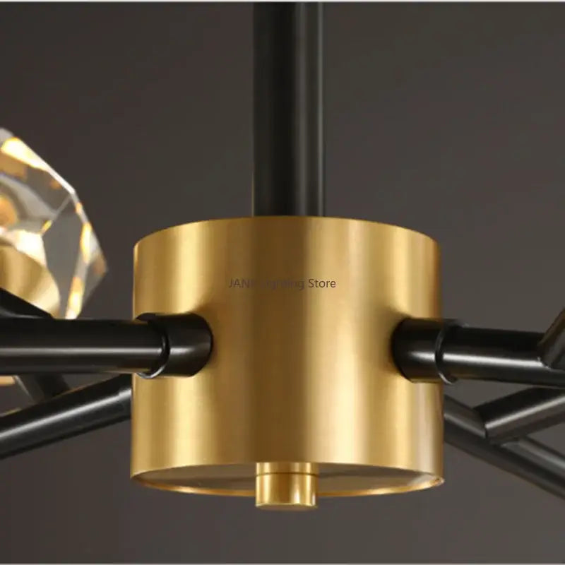Decorbites black gold crystal chandelier with a gold-toned cylindrical base and black metal arms for luxury home decor