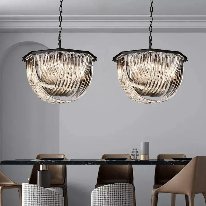 Two elegant black gold crystal glass pendant lights by decorbites black gold hanging above a luxury dining table