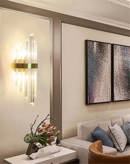DecorBites black gold crystal wall light with gold-toned sconce and vertical prisms casting warm light for bedroom