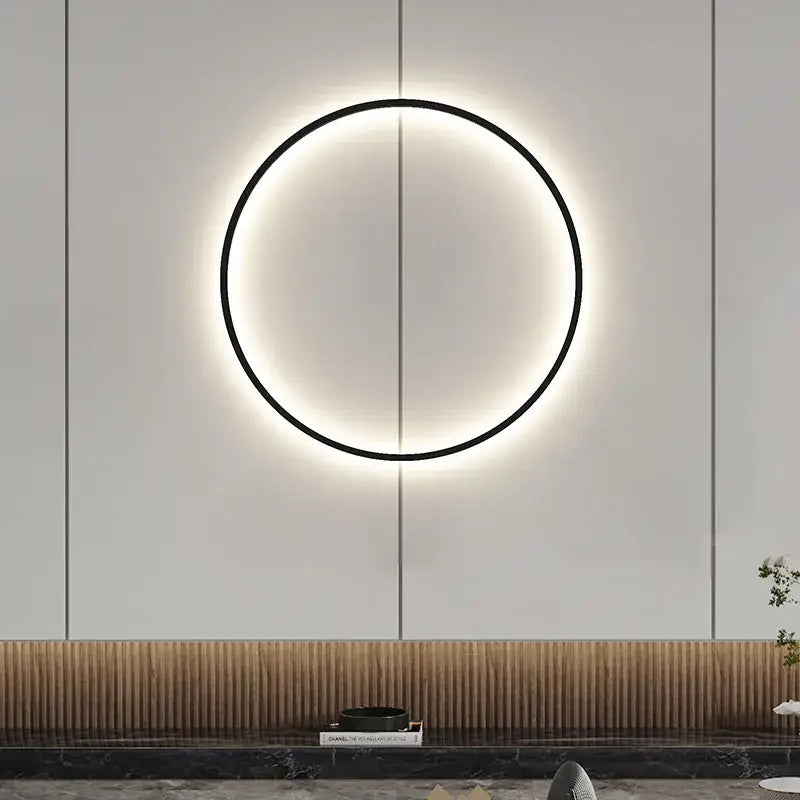 A sleek black circular decorbites black gold dimmable wall light with usb plug and warm glowing ring for bedroom use