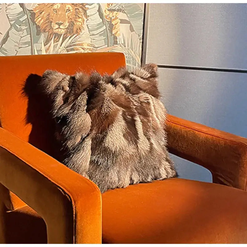 A plush textured DecorBites™ throw pillow case in brown and gray fur on an orange velvet armchair