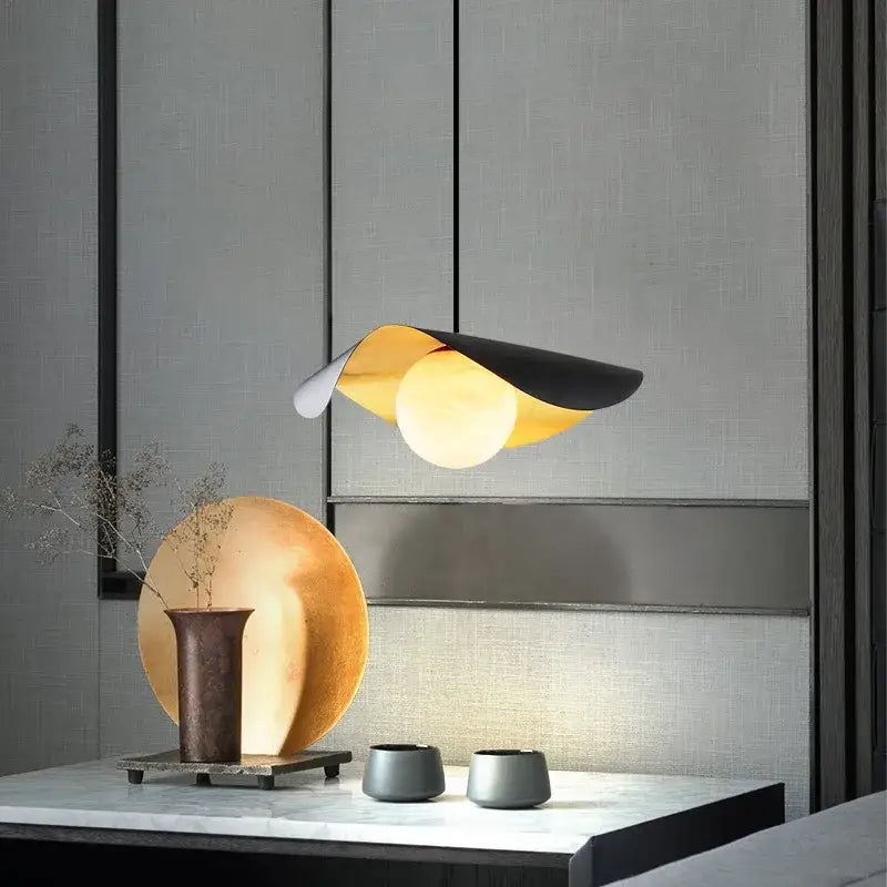 Modern pendant light with sleek curved black gold metallic design by decorbites black gold for retro nordic decor