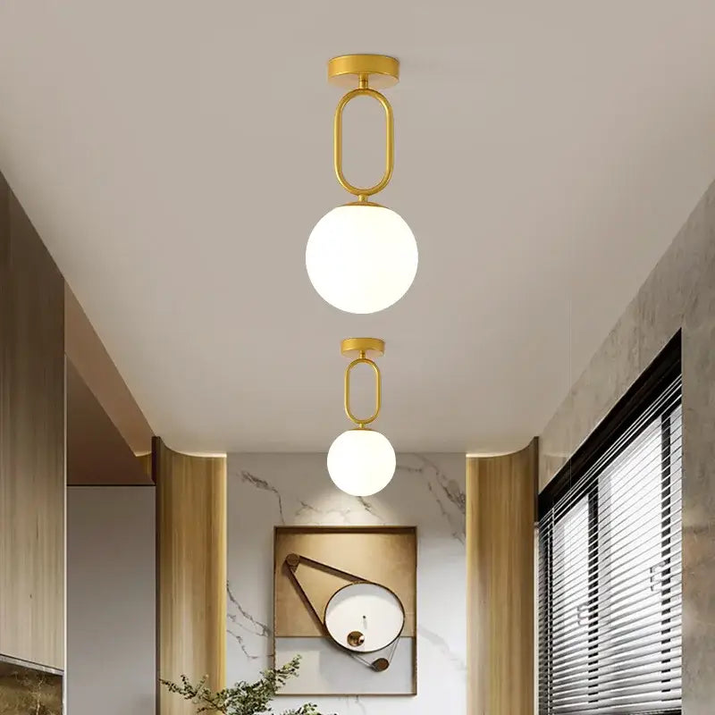 Decorbites black gold glass ceiling lamp featuring gold-finished pendant lights with spherical frosted glass shades