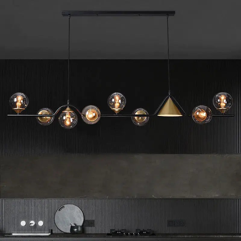 Modern black metal pendant light featuring spherical black gold glass shades and a central gold glass chandelier shade by decorbites black gold