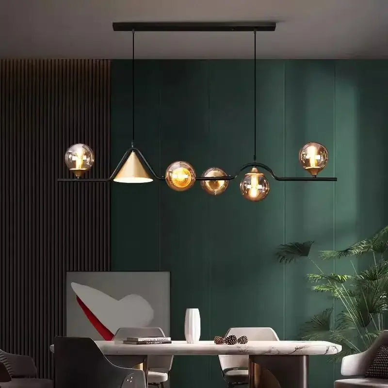 Modern black metal chandelier with five amber glass globes and one conical shade from decorbites black gold glass collection