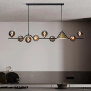 Modern black metal DecorBites black gold glass chandelier with spherical smoked glass shades and gold glass triangular accent