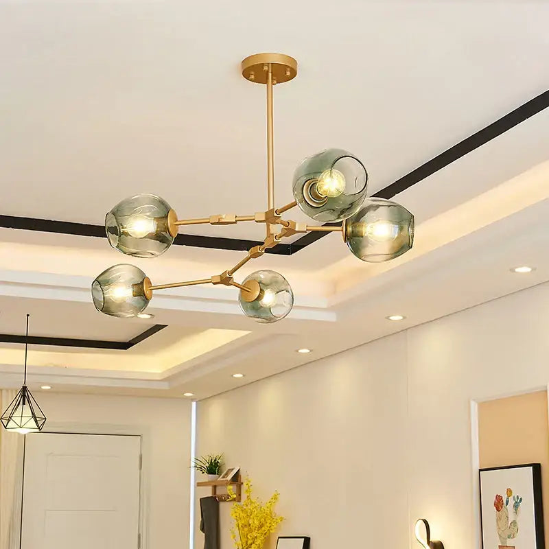 Modern brass chandelier with five translucent green glass globe shades in decorbites black gold glass pendant light
