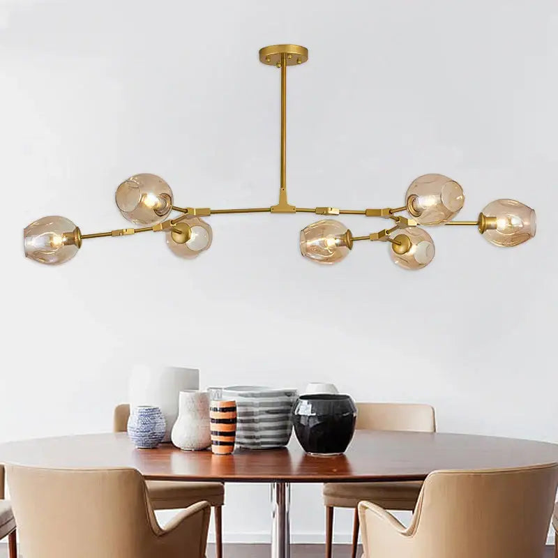 Gold-toned decorbites black gold pendant light with spherical amber glass shades for dining room or loft lighting