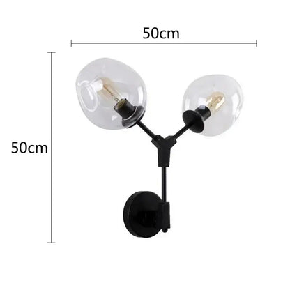 DecorBites black gold wall lamps featuring a black y-shaped metal sconce with two clear glass globe shades