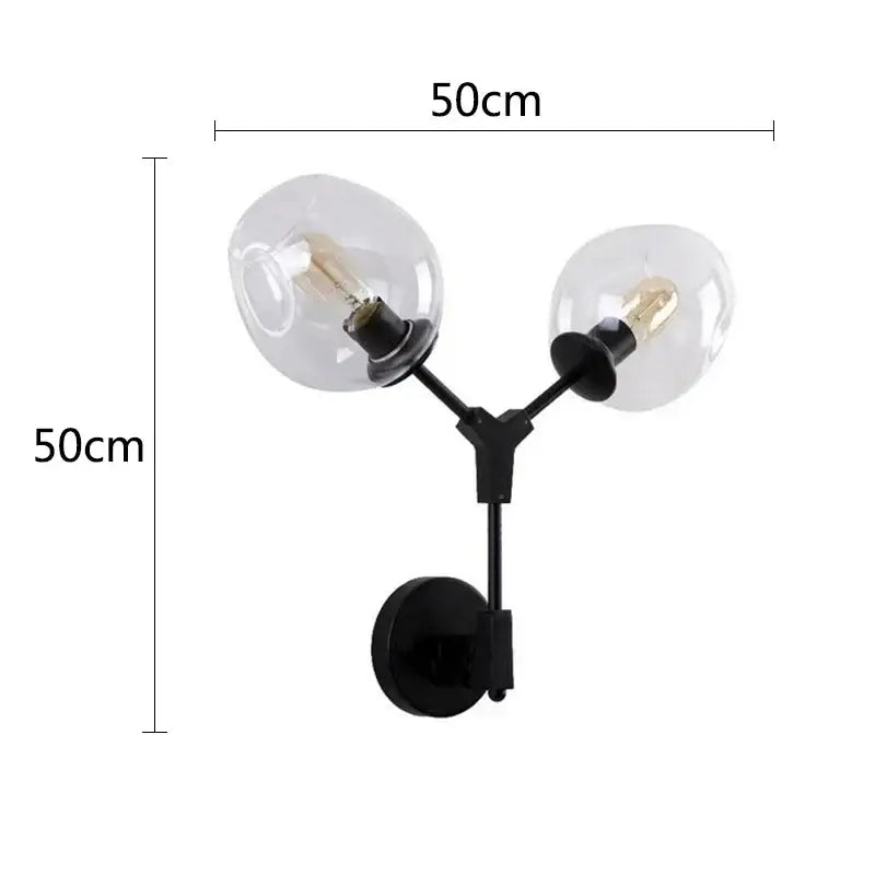 DecorBites black gold wall lamps featuring a black y-shaped metal sconce with two clear glass globe shades