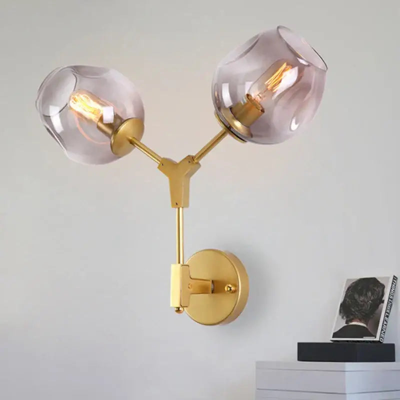 Decorbites black gold wall lamps featuring gold-toned metal with two frosted glass globe shades for modern lighting