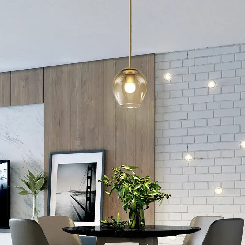 Modern decorbites black gold wall lamp with gold-finished rod and amber glass globe for stylish home lighting