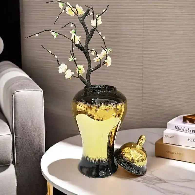 DecorBites black gold gradated ceramic ginger jar with lid holding delicate white blossoms on dark branches