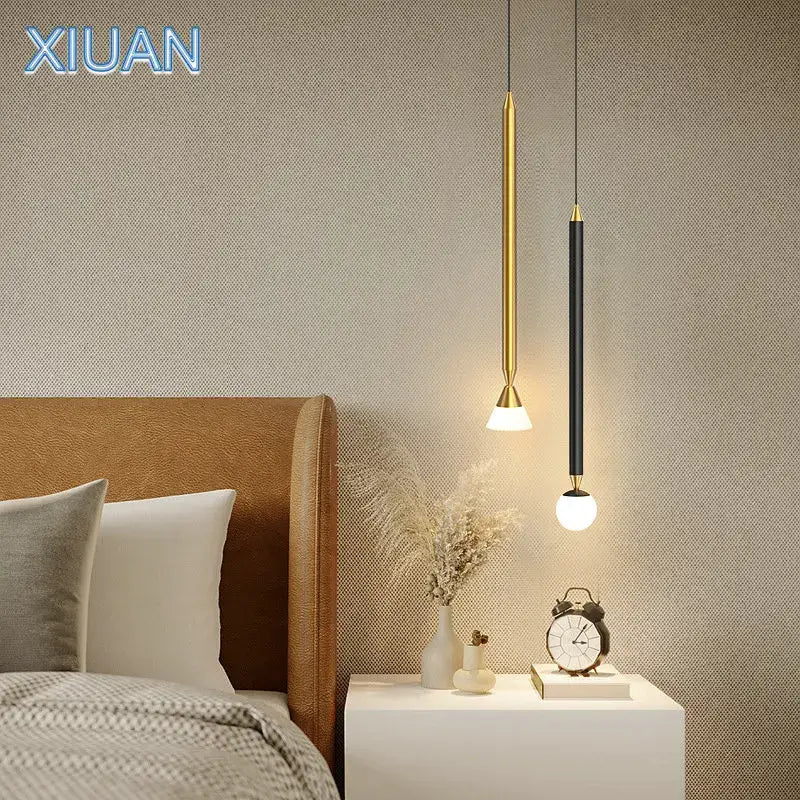 Two modern pendant lights with gold and black finishes feature sleek cylindrical designs in decorbites black gold hanging style