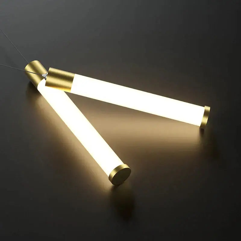 Modern minimalist DecorBites black gold pendant lamp with intersecting cylindrical tubes and warm white LED glow
