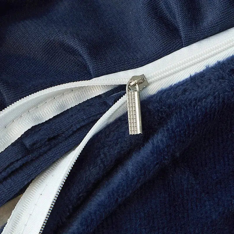 Silver zipper pull with textured grid design on navy blue plush fabric of decorbites black gold lace luxury duvet set