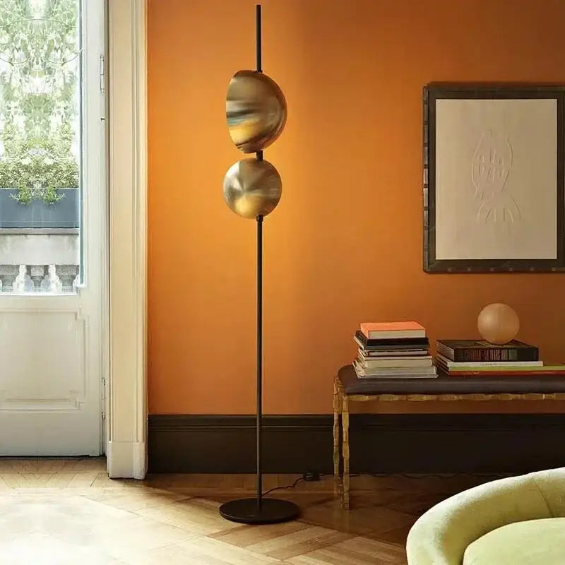 Modern black floor lamp decorbites black gold with two translucent spherical shades emitting warm glow standing light