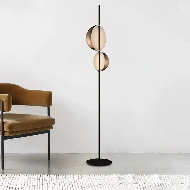 Modern decorbites black gold led floor lamp with two amber glass discs on a sleek black metal pole for elegant lighting