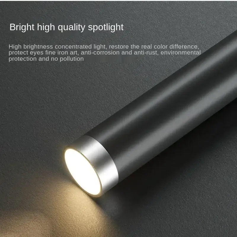 Black cylindrical flashlight with silver metallic ring emitting bright white light in decorbites black gold led pendant lights