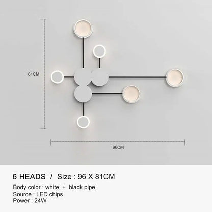 Modern minimalist DecorBites black gold wall lamp with six circular white heads and black piping for indoor use