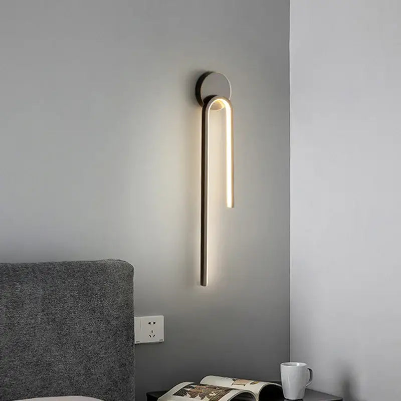 Modern minimalist wall lamp with sleek curved design and warm lighting by decorbites black gold led fixture