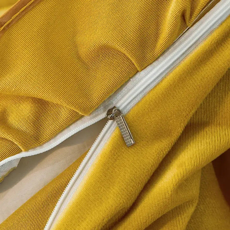 Yellow corduroy fabric with white zipper and silver pull tab detail on decorbites black gold luxury bedding set