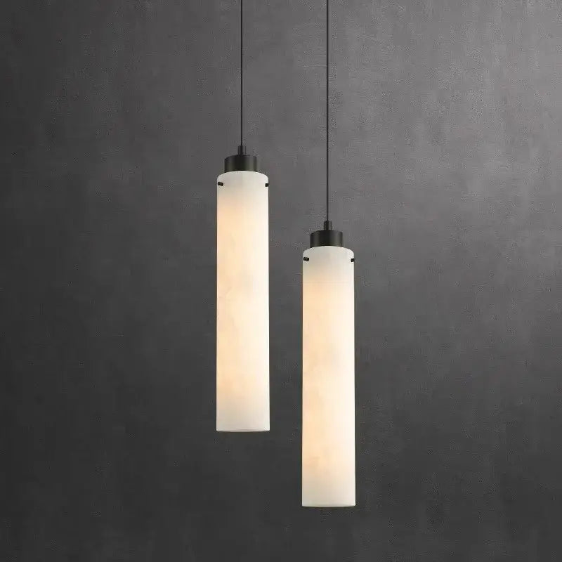 Two sleek matte black decorbites black gold marble pendant lights with frosted white glass shades against dark gray wall
