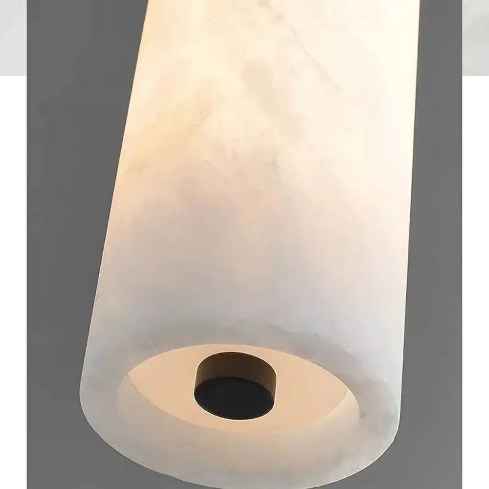 DecorBites black gold marble pendant light with a translucent white cylindrical marble shade and dark circular base fixture