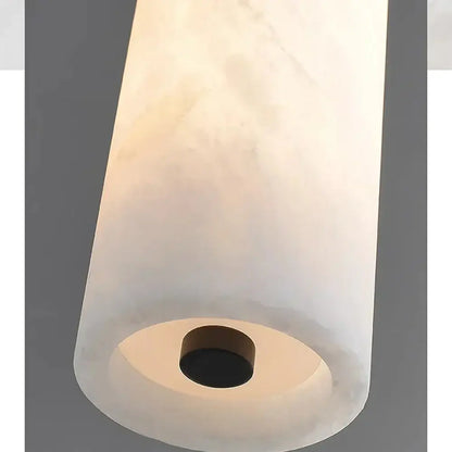 DecorBites black gold marble pendant light with a translucent white cylindrical marble shade and dark circular base fixture