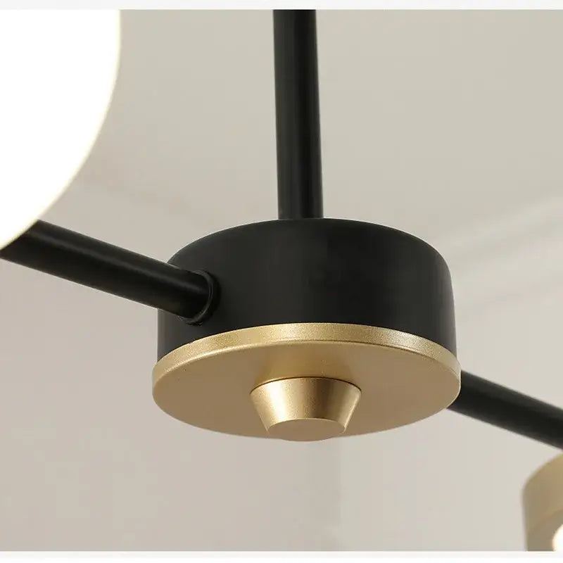 Decorbites black gold minimalist chandelier with sleek cylindrical body and matte metal arms for dining room decor