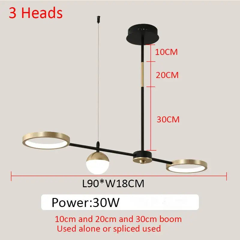 Modern black gold minimalist chandelier by decorbites featuring three black and brass spherical pendant lights for dining room