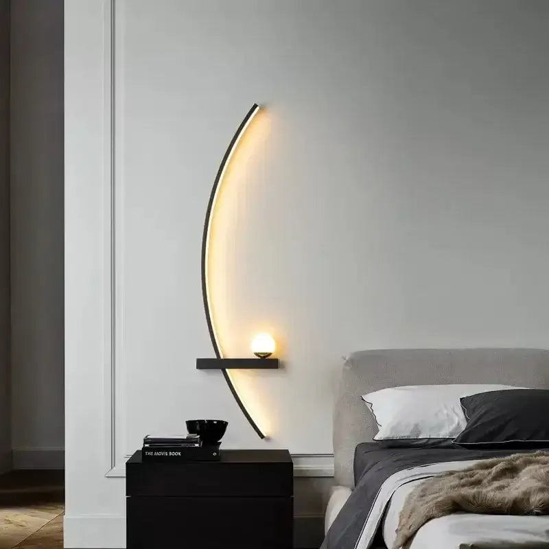 Modern crescent-shaped wall sconce with sleek black frame and warm ambient lighting from decorbites black gold collection