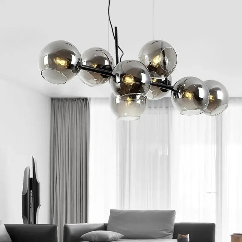 Modern chandelier featuring multiple smoked glass spheres on a black gold metal frame by DecorBites black gold
